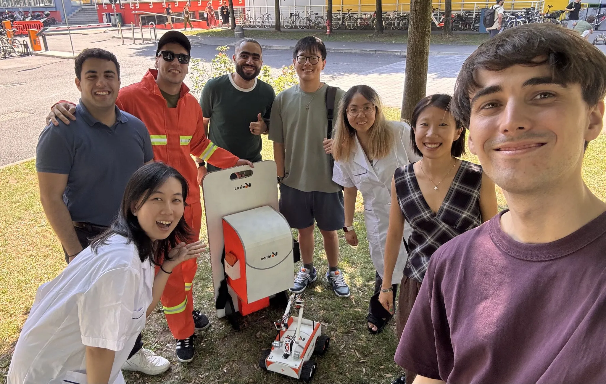 A selfie of the team with the robot and its case